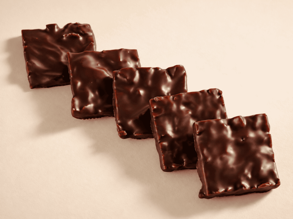 Amande effilée et caramélisée, orange confite et miel enrobé de chocolat noir  - 160g
